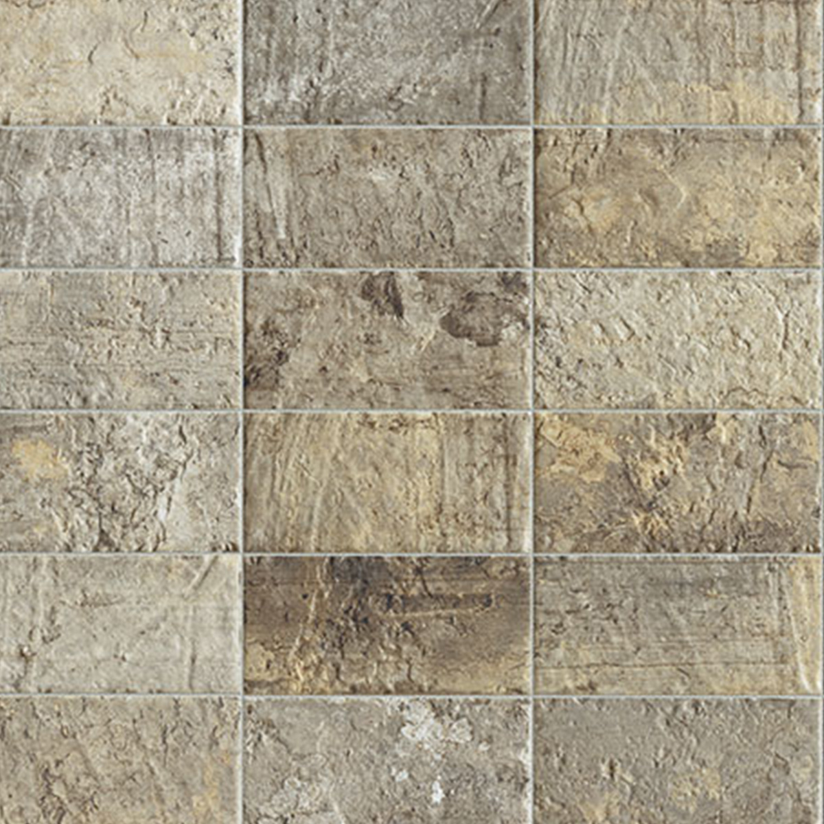 Close-up of rectangular stone-look tiles in warm sandy beige, taupe, and golden brown tones with a heavily textured, rough surface and strong natural variation, laid in a horizontal running bond pattern with thin grout lines.