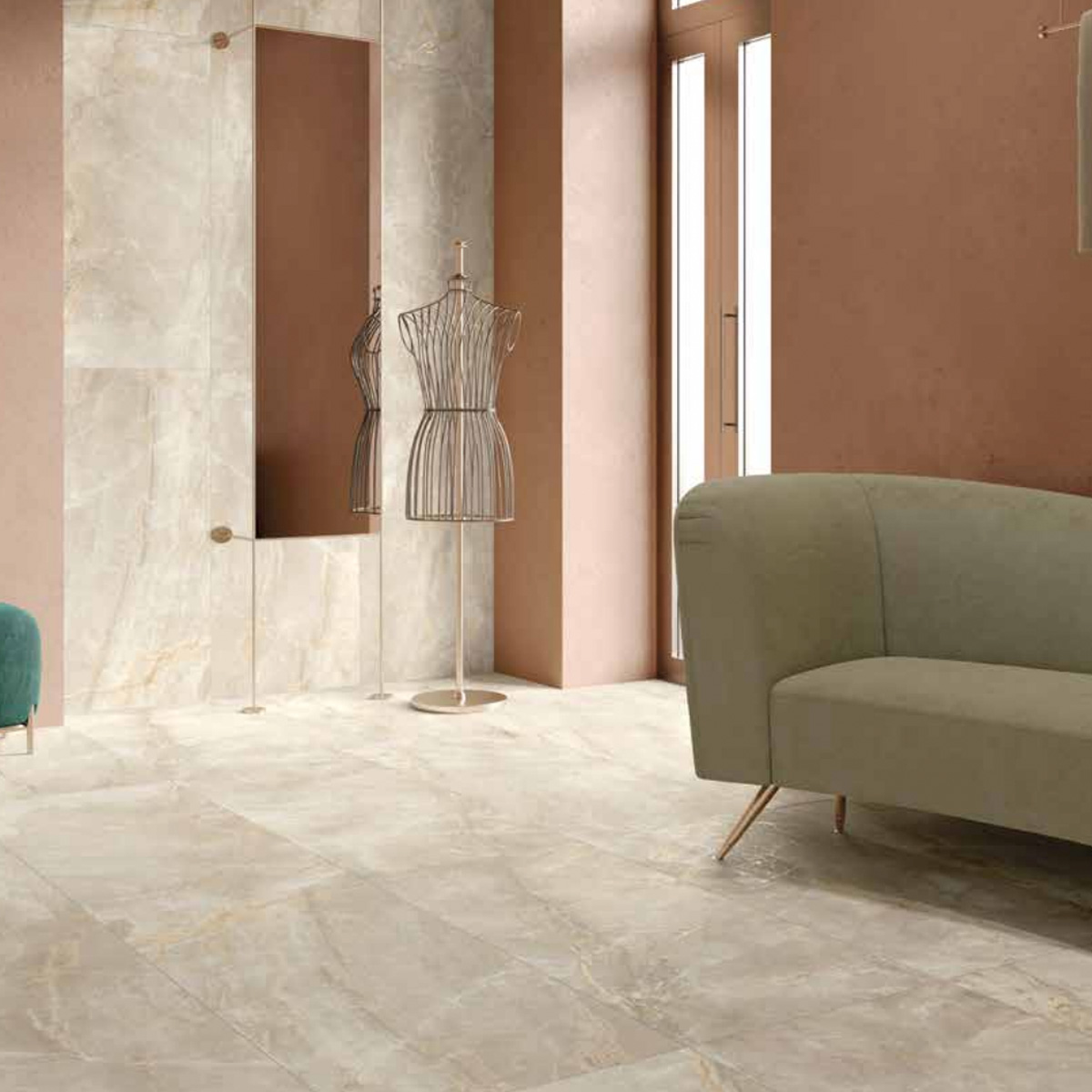 A modern room with Charme - Ivory marble tile flooring, a beige curved sofa, a standing mirror, a metal dress form, and large windows letting in natural light. The walls are painted a warm, muted brown.