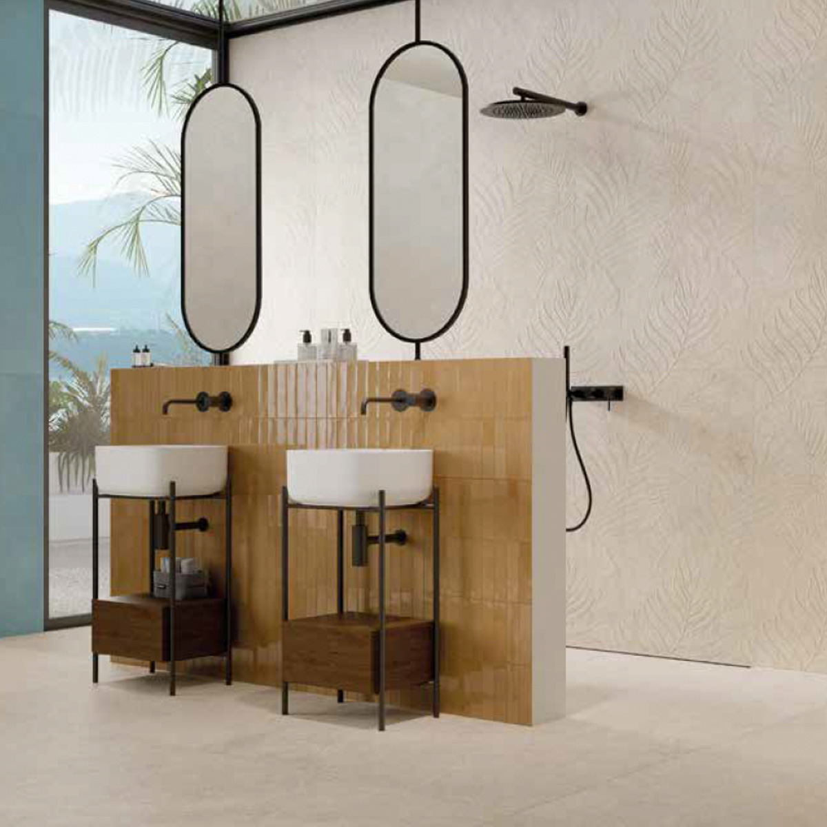 Modern bathroom featuring two sinks with wood and metal stands, oval mirrors, and a wall-mounted showerhead. The partition wall is covered in Lutezia - Ivory tiles, while large windows offer views of palm trees and the outdoors.