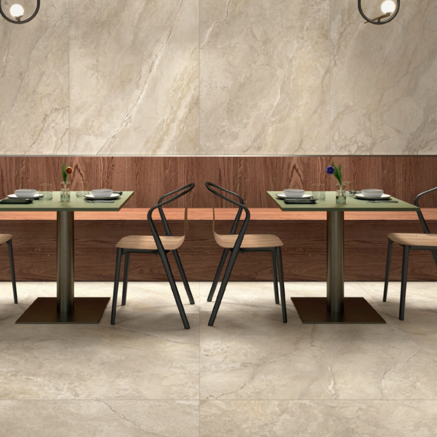 A modern restaurant interior featuring two square tables and four chairs, complemented by minimal table settings. The flooring showcases Anthology/Anthea - Desert marble tiles, while wood paneling decorates the walls. Two hanging lights are visible at the top corners.