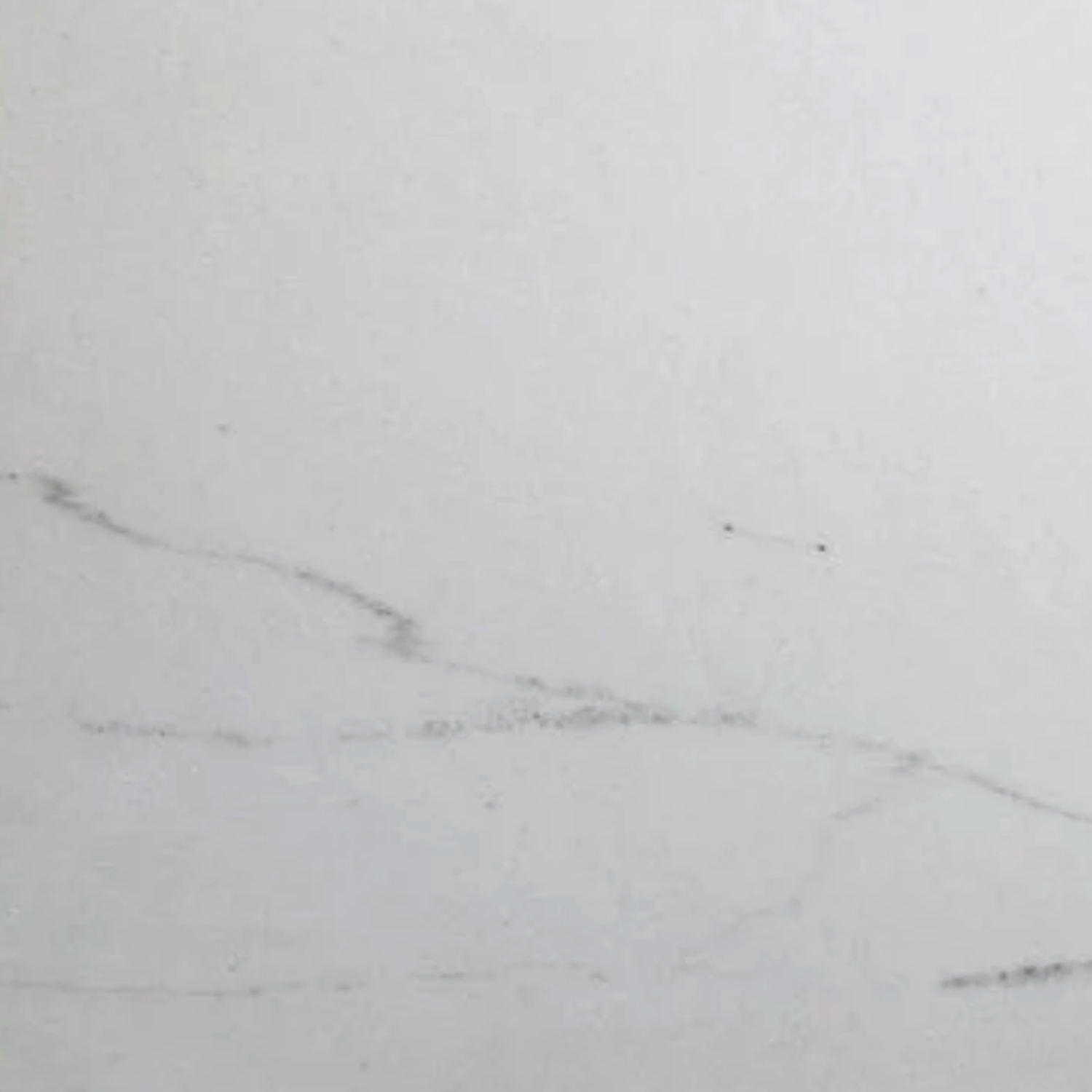 Colorado Calacatta Bath Accessories (Bevel Seat) feature a pristine white marble surface adorned with delicate, thin gray veining running diagonally, offering a smooth, clean texture for a minimalist and elegant look.