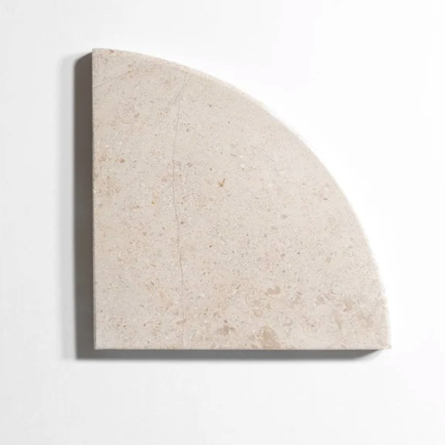A Bath Accessories (Corner Shelf) - Bellagio Beige, shaped like a quarter circle in beige stone, placed on a white background with a light shadow along its curved edge.