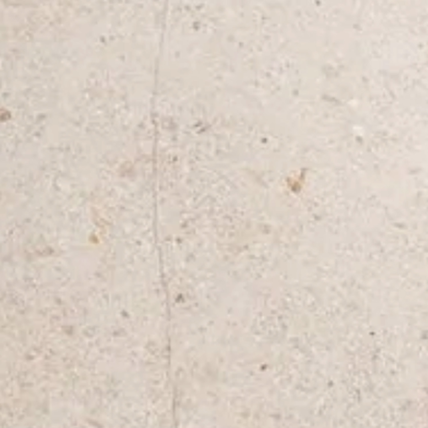 A close-up view of the Bellagio Beige Bath Accessories corner shelf, showcasing its beige, speckled stone surface with a faint vertical crack running through the center.