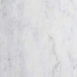 A Venatino Carrara Bath Accessories Corner Shelf, crafted from white marble with subtle gray veining, is mounted on a plain white wall, casting a faint shadow to the left and below.