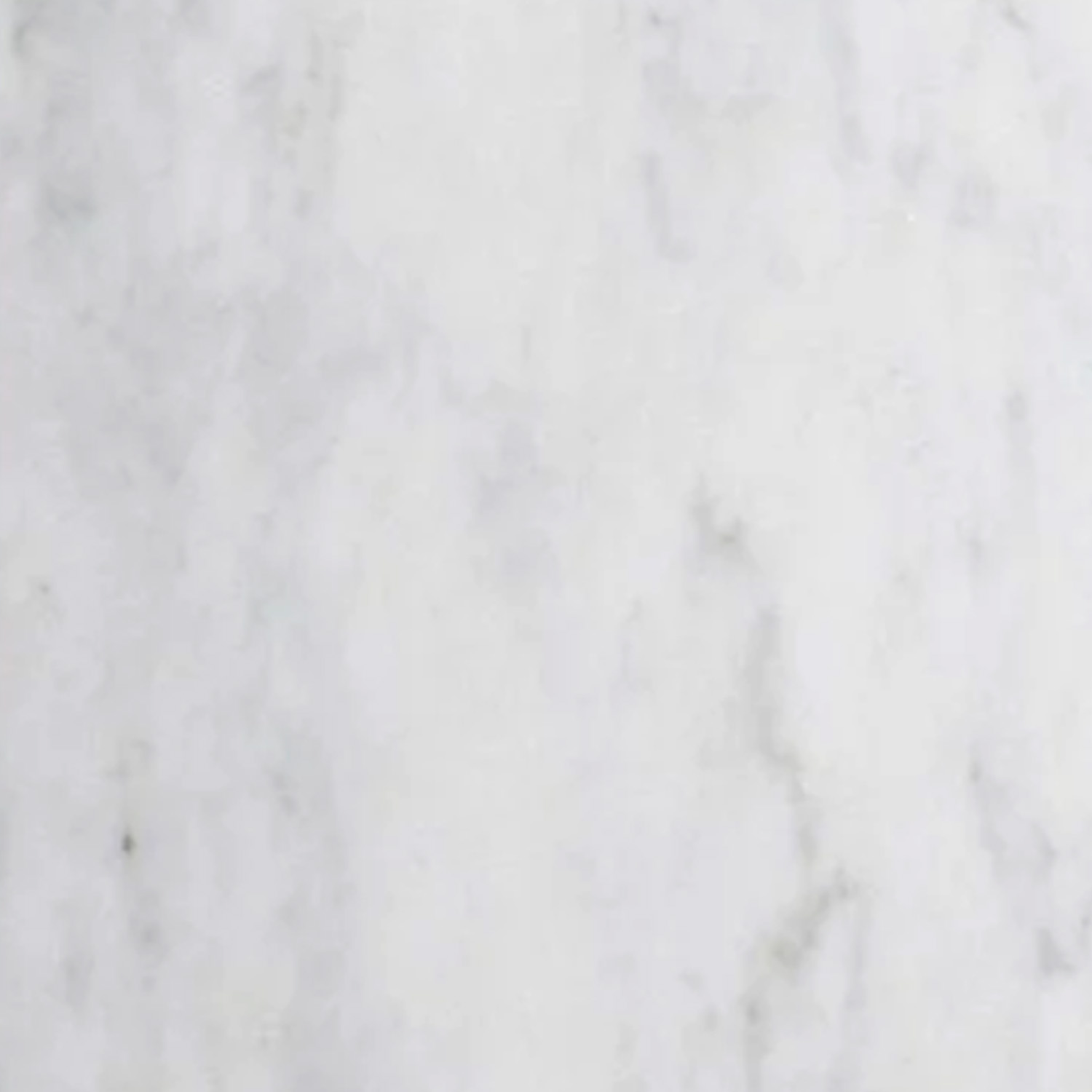 A close-up of the Venatino Carrara Bath Accessories (Corner Shelf) reveals a white marble surface with subtle gray veining running throughout, featuring a smooth and polished texture.