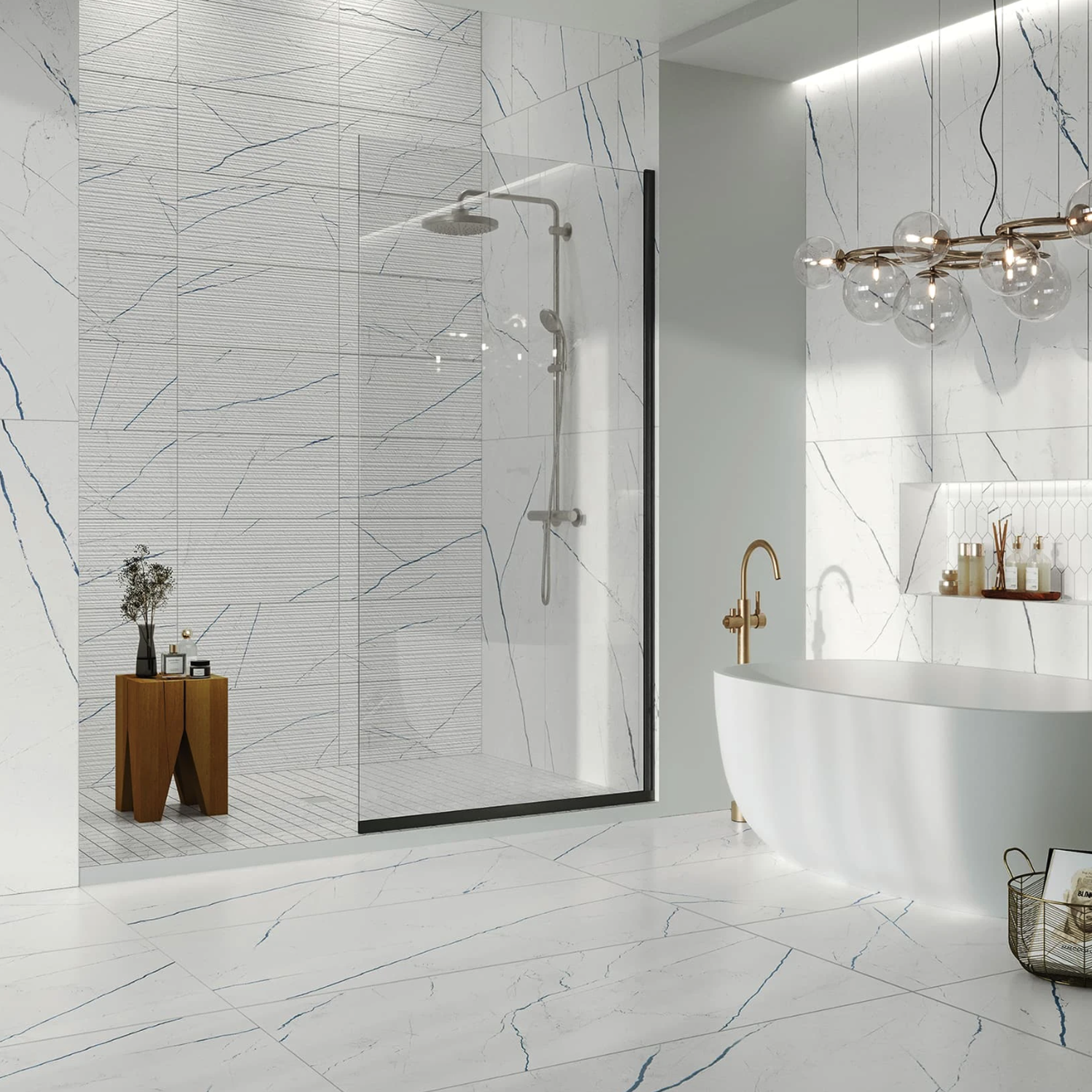 Modern bathroom featuring Beyond Calacatta - Ocean White marble walls and floor, a glass shower enclosure, freestanding bathtub with elegant gold fixtures, and a wooden stool adorned with decor items. A hanging glass light fixture is suspended above the bathtub.