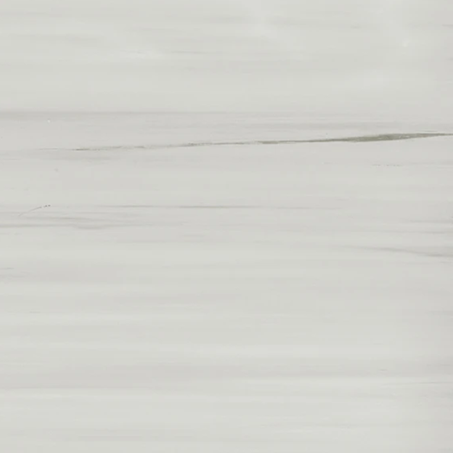A close-up of Beyond Dolomite - Gray reveals a smooth, light gray marble surface featuring subtle, wavy white and gray veining running horizontally across the image.
