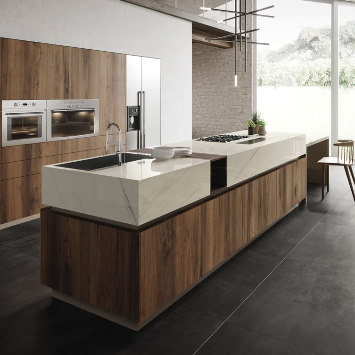 Modern kitchen with a large island featuring wood and Bianco Dolomite A marble finishes, built-in appliances, a sink, and floor-to-ceiling windows letting in natural light. Minimalist decor with black floor tiles and sleek lighting.