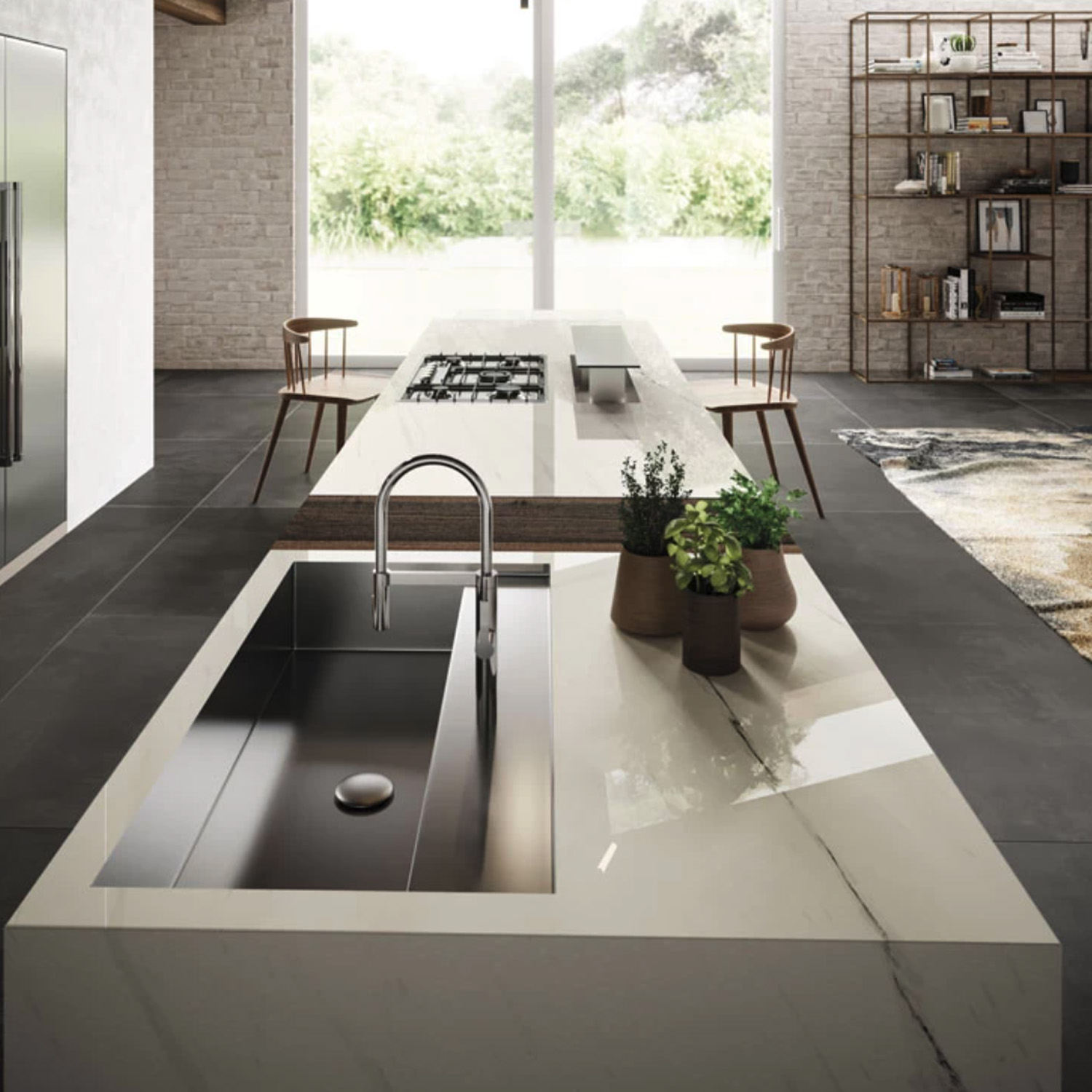 Modern kitchen featuring a Bianco Dolomite A marble island, built-in stainless steel sink, potted plants, gas cooktop, wooden chairs, and large windows overlooking greenery.