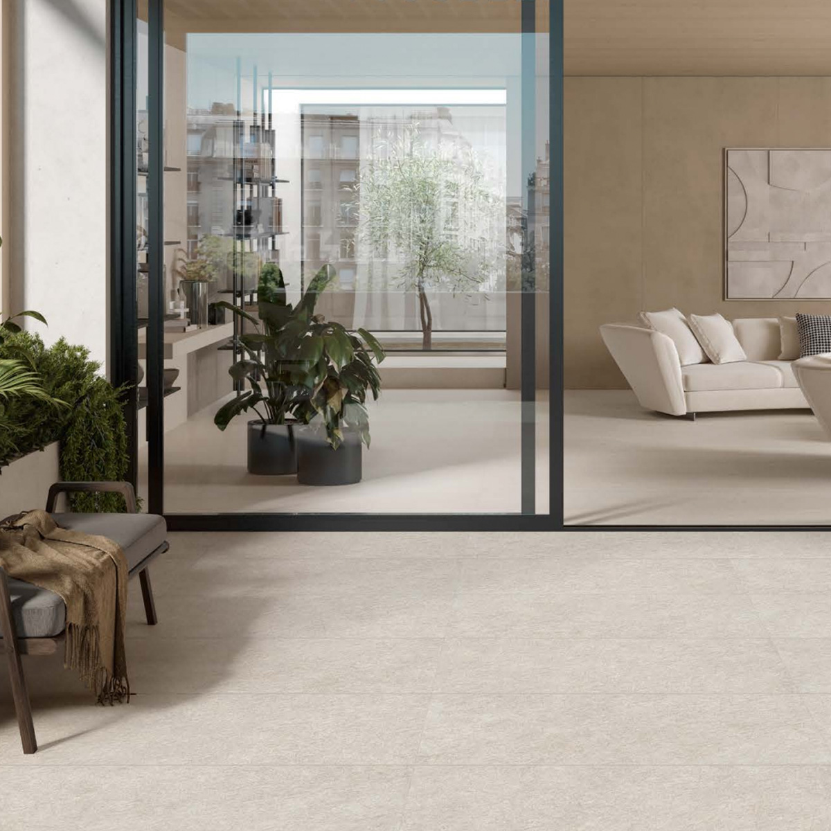 Modern living room featuring Boost Mineral - White tile floors, large glass doors, indoor plants, a white sofa, and a small painting on the wall. Outside the doors, more greenery and tall buildings can be seen in the background.