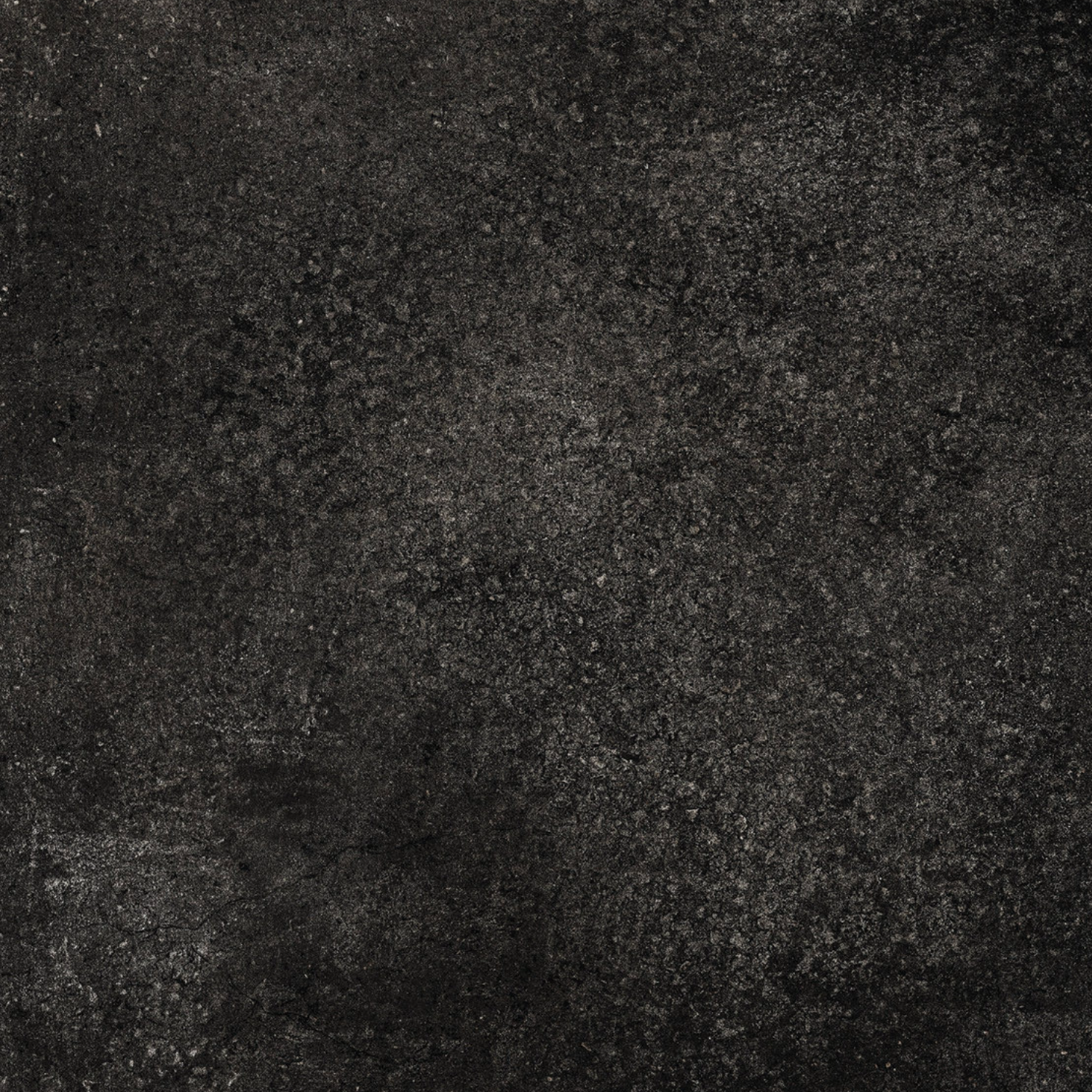 Brooklyn - Cemento Black features a dark, textured surface with a rugged, mottled appearance reminiscent of weathered concrete or stone, highlighted by varied shades of black and gray throughout.