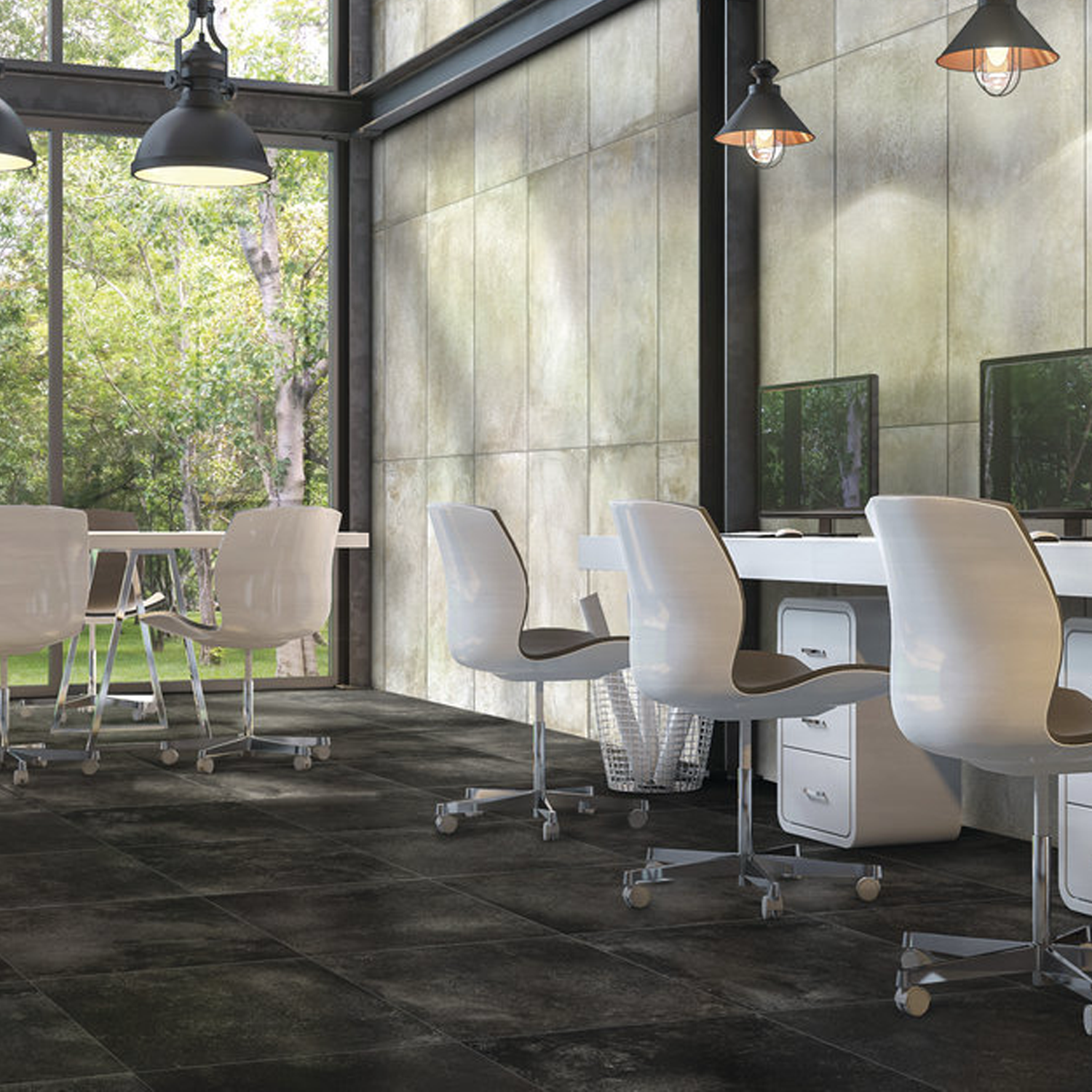 A modern office features white chairs and desks, computers, hanging lights, and large windows overlooking lush greenery. The clean, industrial space is finished with concrete walls and a dark tiled floor in Brooklyn - Cemento Black.