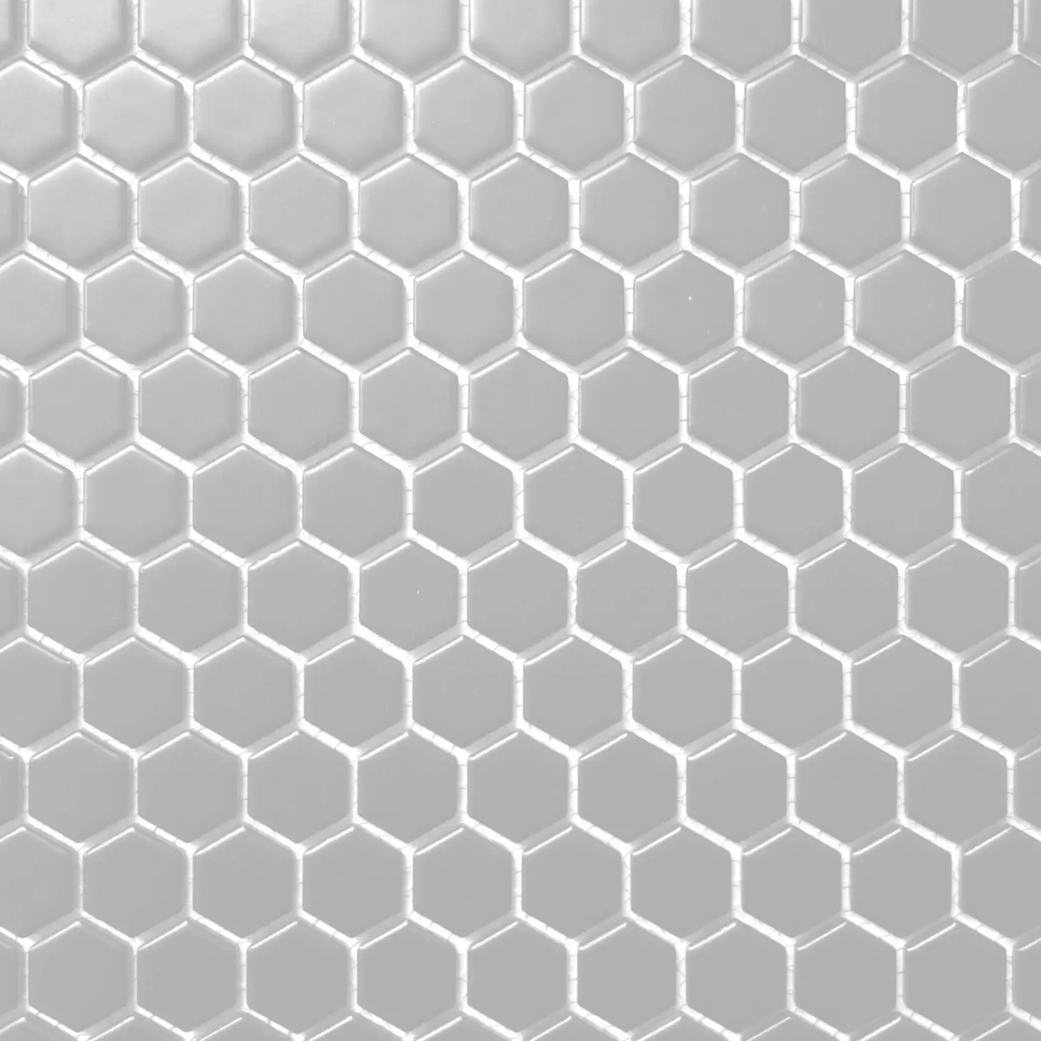 Large-format grey hexagonal tiles from CC Mosaics - Grey are arranged in a honeycomb pattern, creating a geometric and textured surface. The grout lines between the tiles are visible, contributing to a clean and modern overall design.