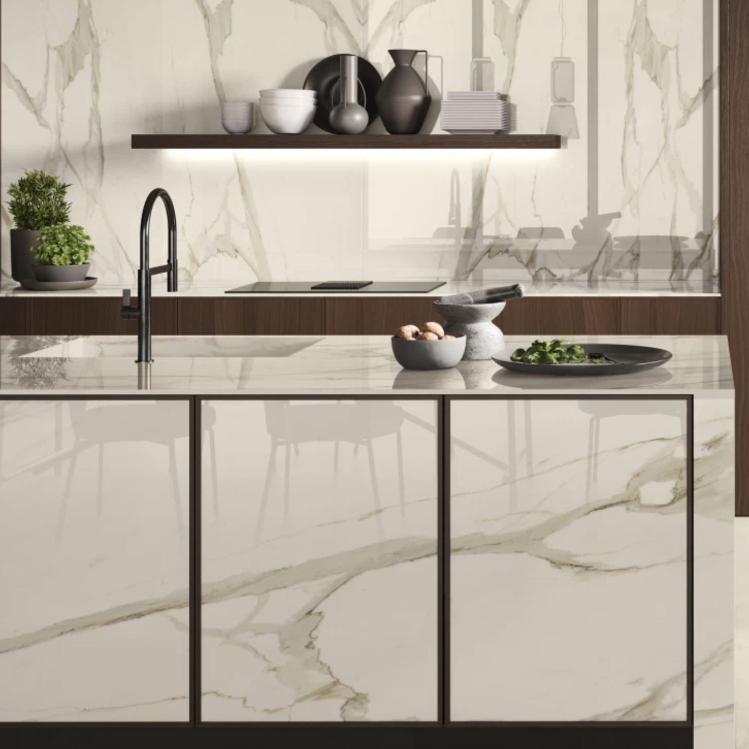 Contemporary kitchen featuring Calacatta Borghini / Bernini marble surfaces, an island sink, a cutting board with fresh ingredients, black dishware, potted greenery, and open shelving displaying neatly stacked bowls and plates against a striking Calacatta Borghini / Bernini marble backsplash.