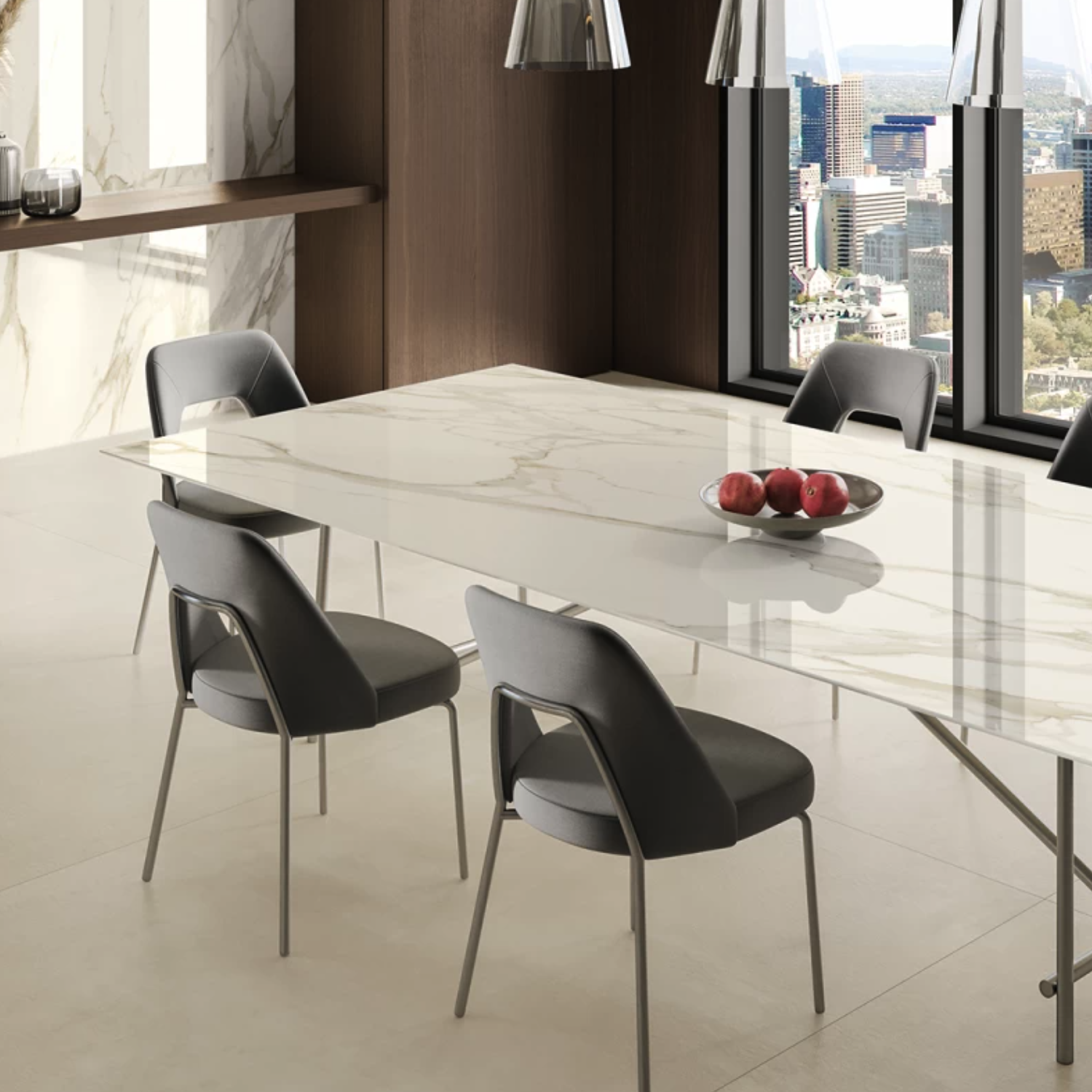 A modern dining room with a Calacatta Borghini / Bernini marble table, four gray chairs, a bowl of red apples, floor-to-ceiling windows overlooking the city. Calacatta Borghini / Bernini marble walls and flooring complete the sophisticated, minimalist décor.