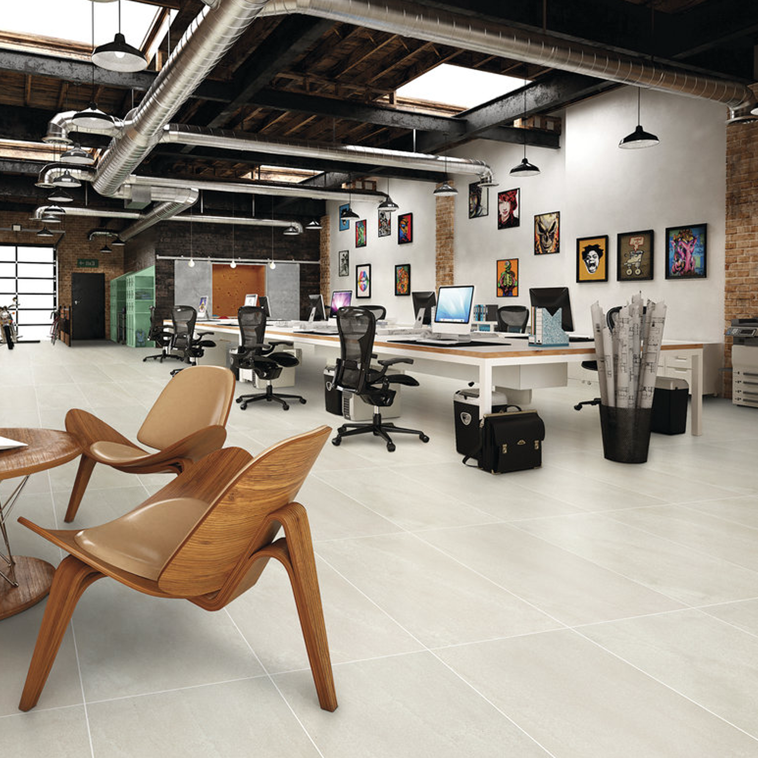 Contemporary open-plan office featuring exposed brick walls, ceiling ducts, desks with computers, ergonomic chairs, wall art, and Carrara Select - Carrara Gioia wooden lounge chairs in the foreground.