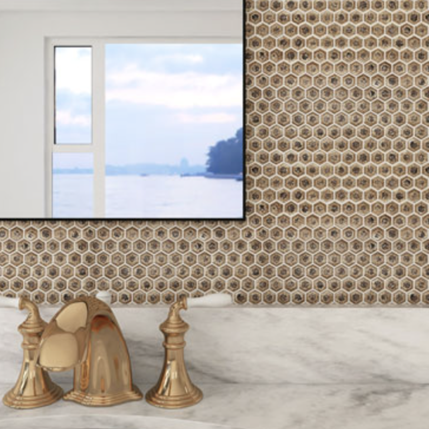 A Chameleon - Rustic Sunset hexagonal mosaic tile wall sets the backdrop for a marble countertop with gold sink fixtures, complemented by a mirror reflecting a serene sky and water view.