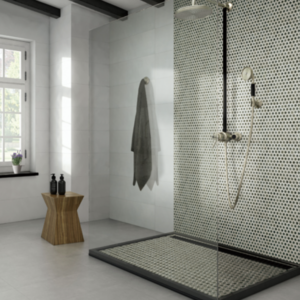 Modern bathroom with a glass shower featuring Chameleon - Sage Green small hexagon tiles, a rainfall showerhead, a towel hanging on the wall, two bottles on a wood stool, and natural light from a window.
