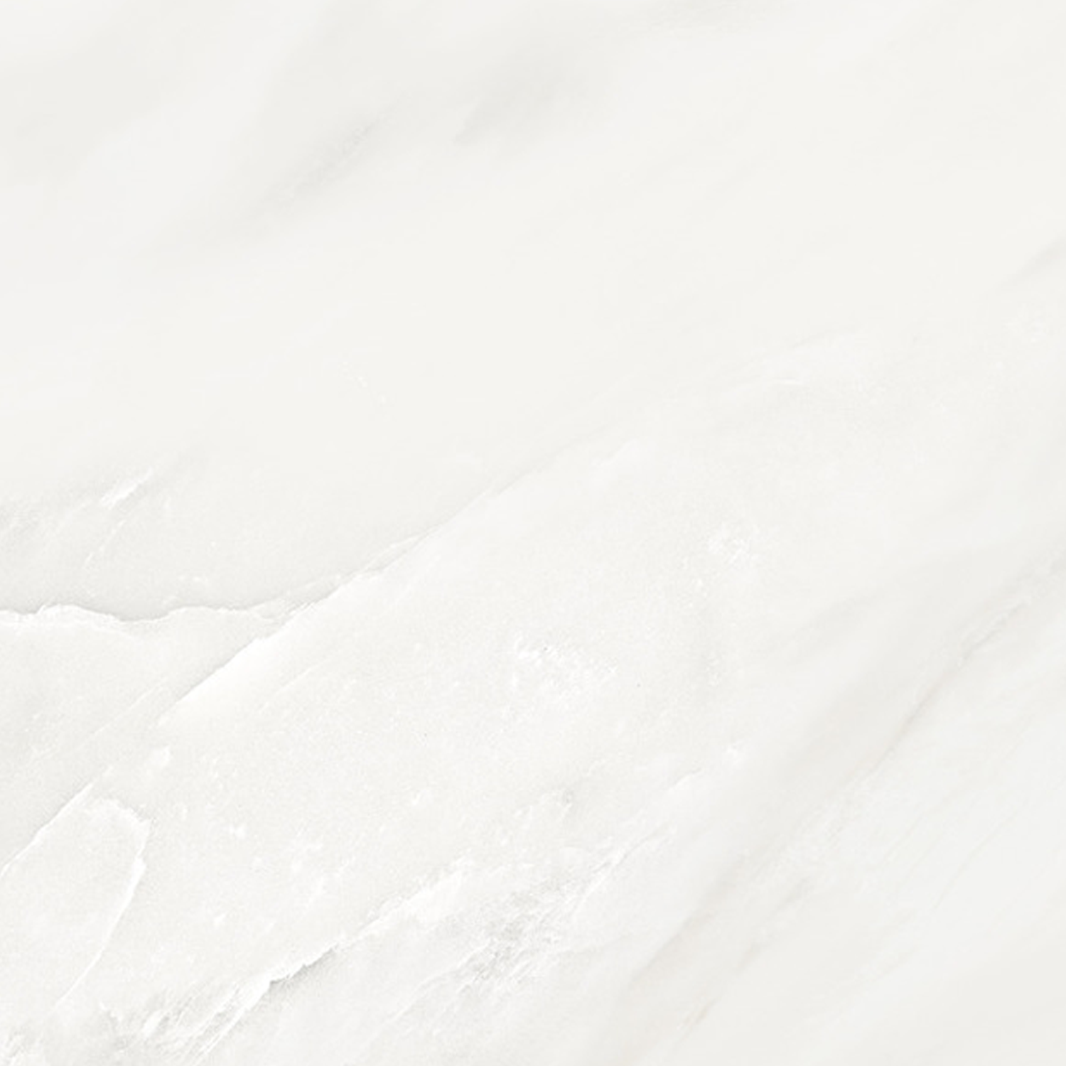 A polished white marble surface from Classic Boutique - Delicato Bianco, featuring delicate gray veins that run diagonally, exudes a luxurious and refined elegance with its clean and sophisticated appearance.