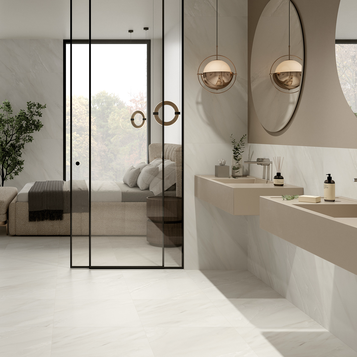 Experience a modern bathroom featuring Classic Boutique - Delicato Bianco sinks in beige, complemented by a large round mirror, pendant lighting, and glass doors that open to a bedroom with a bed and an expansive window. The space is styled with minimalist decor, including a potted plant and a soothing neutral color palette.