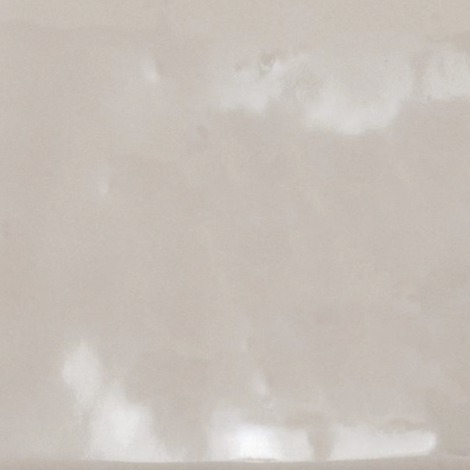 A close-up of Cromia26 - Beige 2 reveals a smooth, light beige surface with subtle glossy patches and gentle reflections.