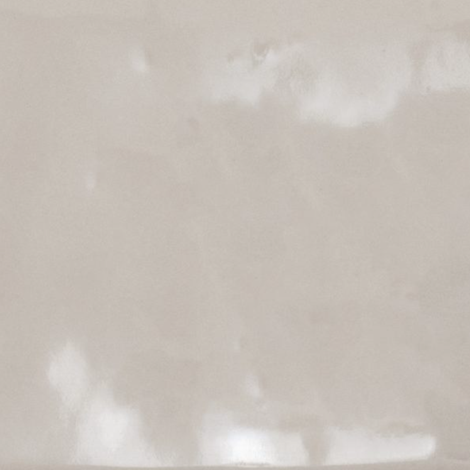 A close-up of Cromia26 - Beige 3 shows a smooth, light beige surface with subtle, cloudy patterns and gentle reflections, suggesting high-quality ceramic tile or polished stone.