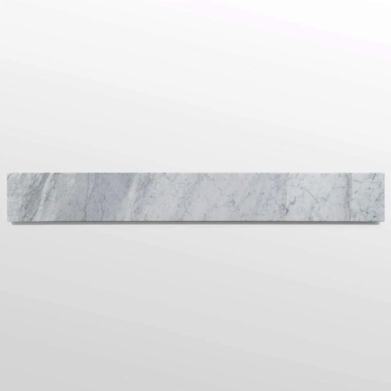 A long, rectangular slab of Curbs - Venatino Carrara marble, featuring light gray veining on a white surface, displayed against a plain white background.