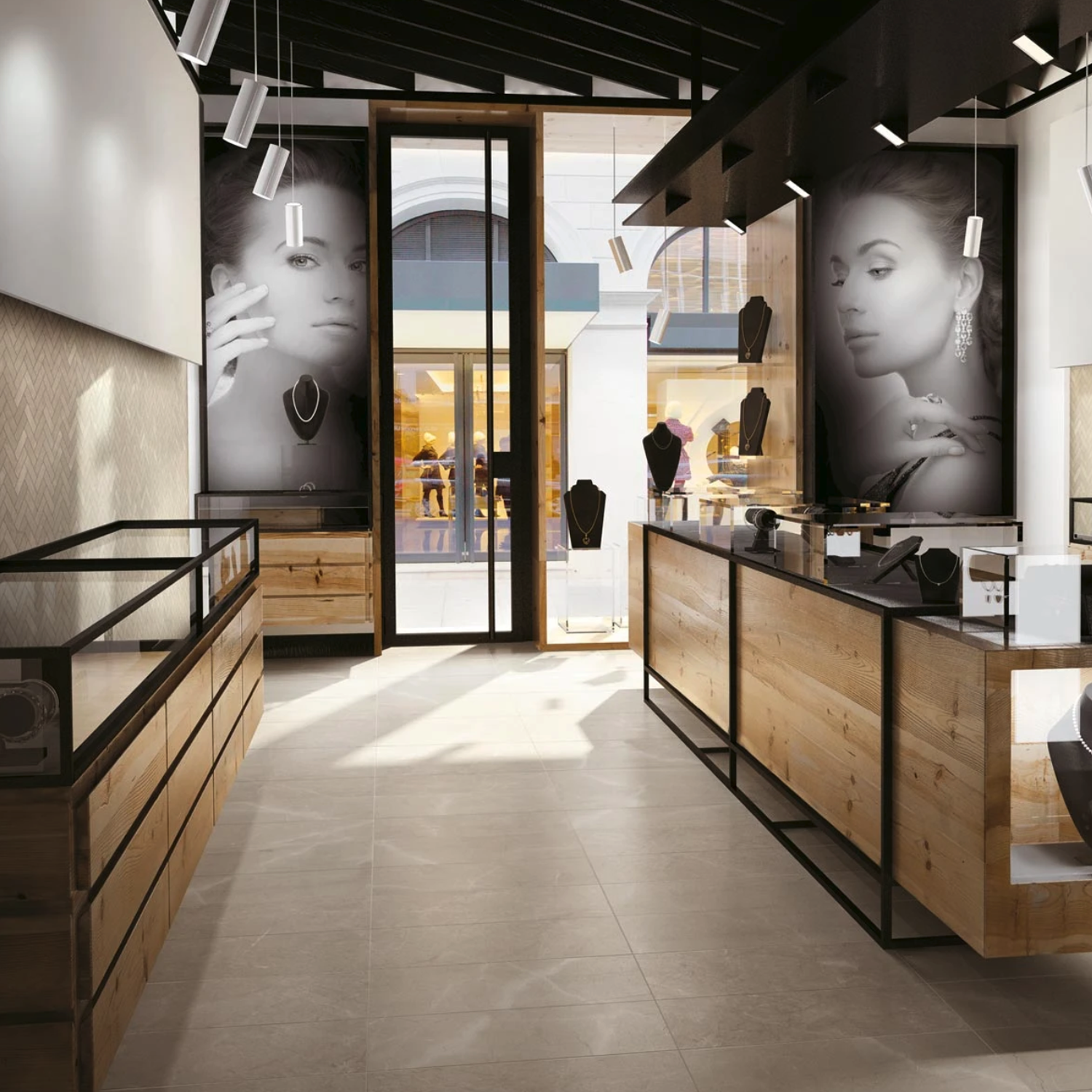 A modern jewelry store interior showcases glass display cases, elegant wooden counters, and large black-and-white posters of a woman modeling jewelry on the walls. The space is illuminated by bright lighting and abundant natural light streaming through floor-to-ceiling windows, all beautifully complemented by Eon - Corinthian Beige surfaces.