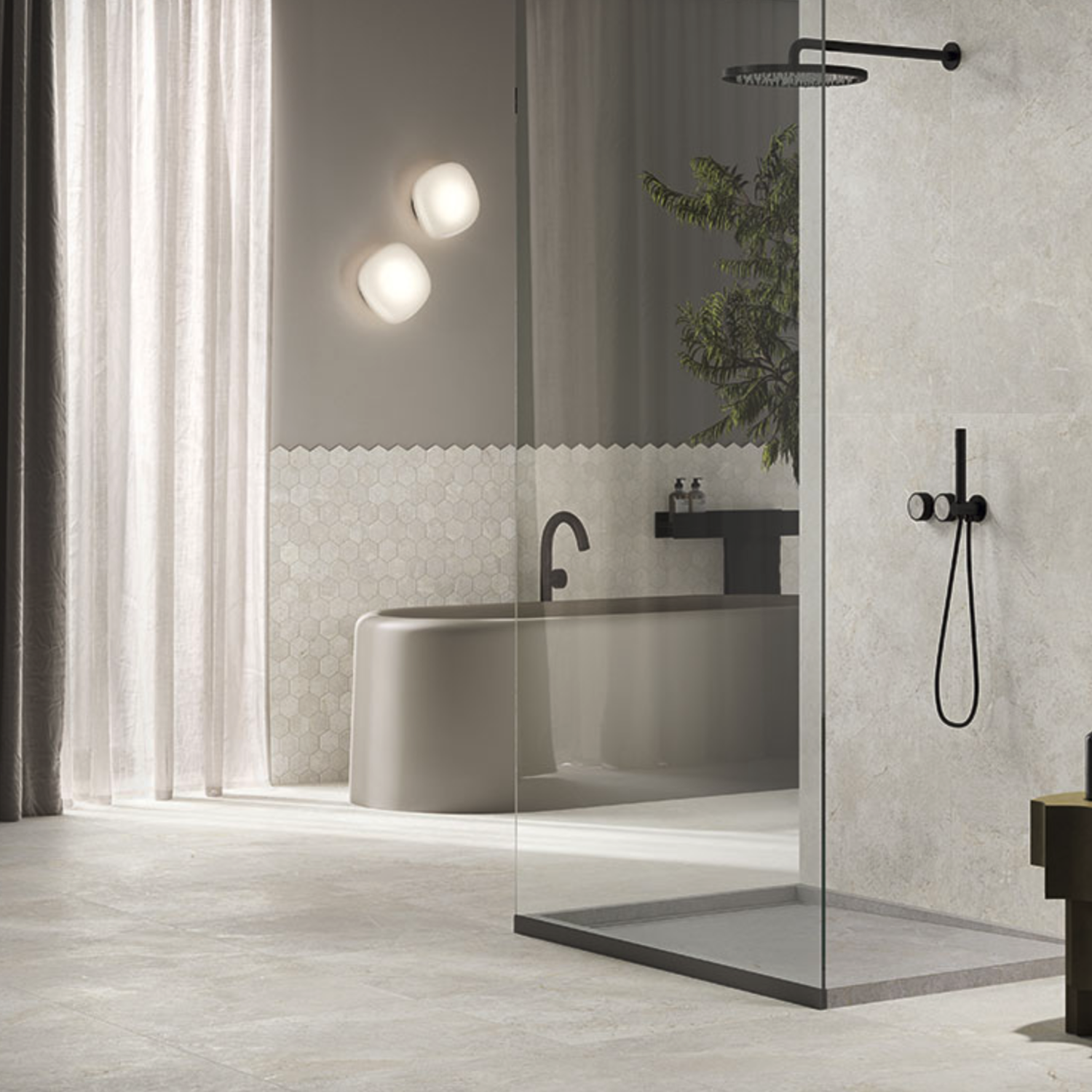 Modern bathroom with a glass shower, freestanding tub, black fixtures, Everstone - Ever White textured light gray tile, hexagon backsplash, translucent curtains, and a green plant near the tub.