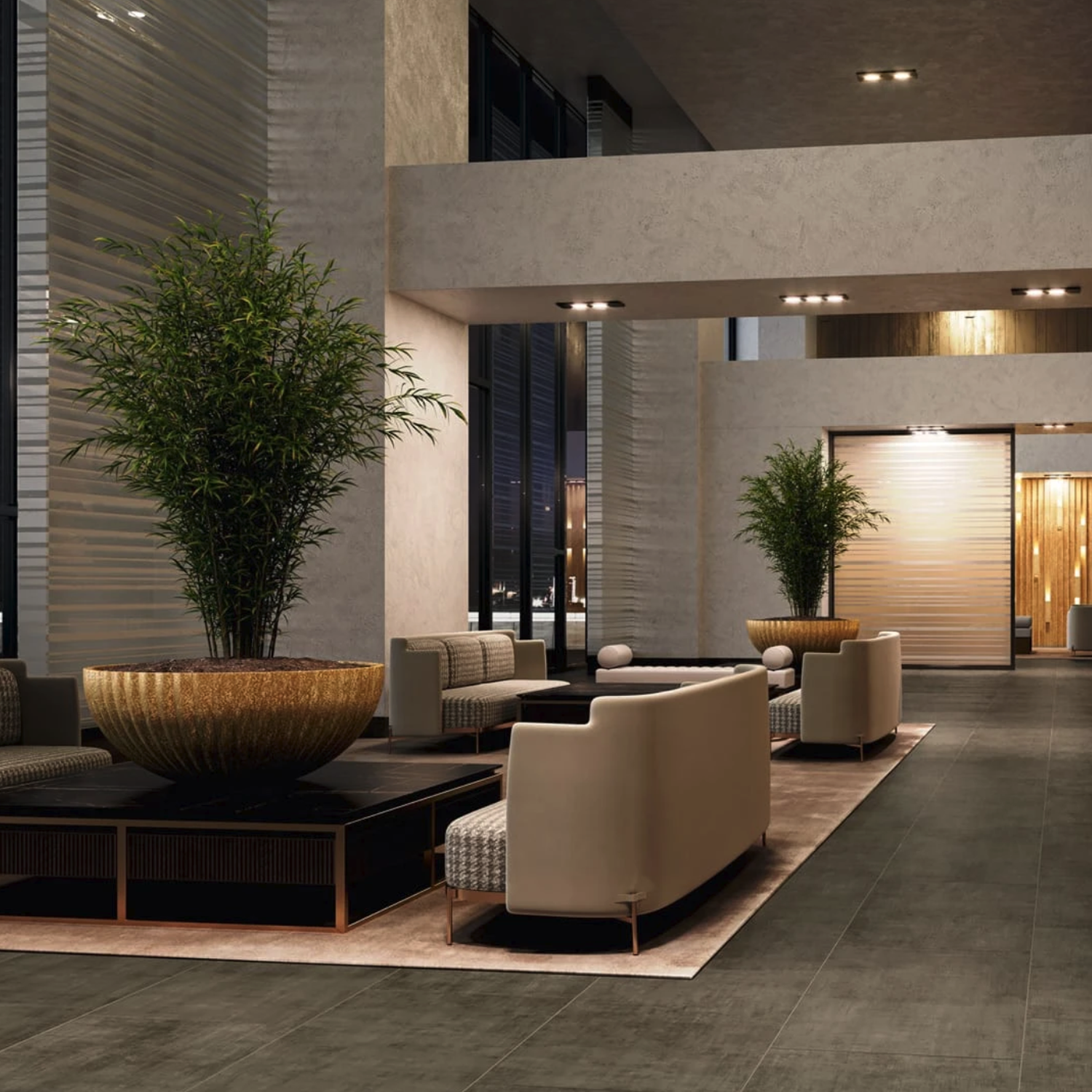 Modern hotel lobby with elegant seating featuring the Fray - Tobacco sofas, large potted plants, neutral-toned armchairs, and soft lighting, creating a welcoming and stylish atmosphere.
