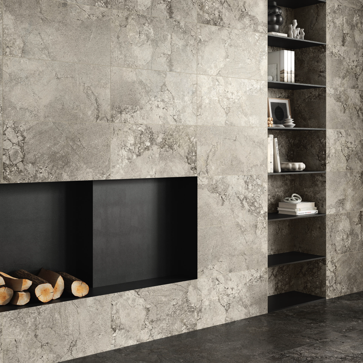 Gray Lythos wall with a built-in black fireplace, stacked firewood, and open shelving on the right holding books, vases, and small decorative items. The floor also features matching Lythos - Grey stone tiles.