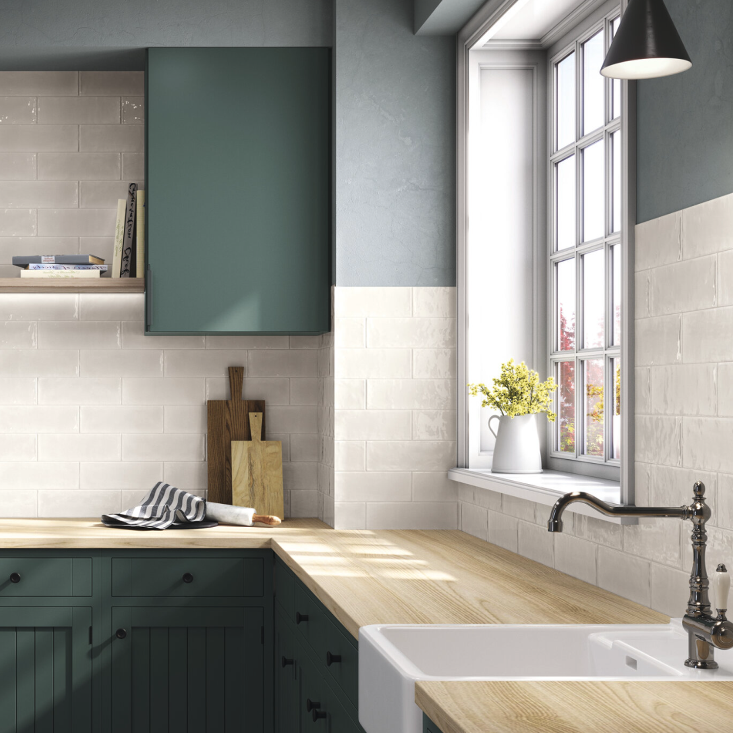 Modern kitchen with green cabinets, wooden countertops, white tile backsplash, a farmhouse sink, and a window letting in natural light. A Pim Pam Pum - Pum White pitcher with yellow flowers sits on the windowsill.
