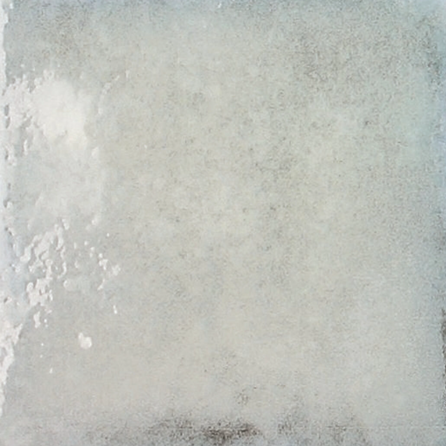 Savannah - Berilo is a square ceramic tile featuring a subtly textured, uneven white surface accented with delicate grayish speckles and patches, creating a weathered and natural look.