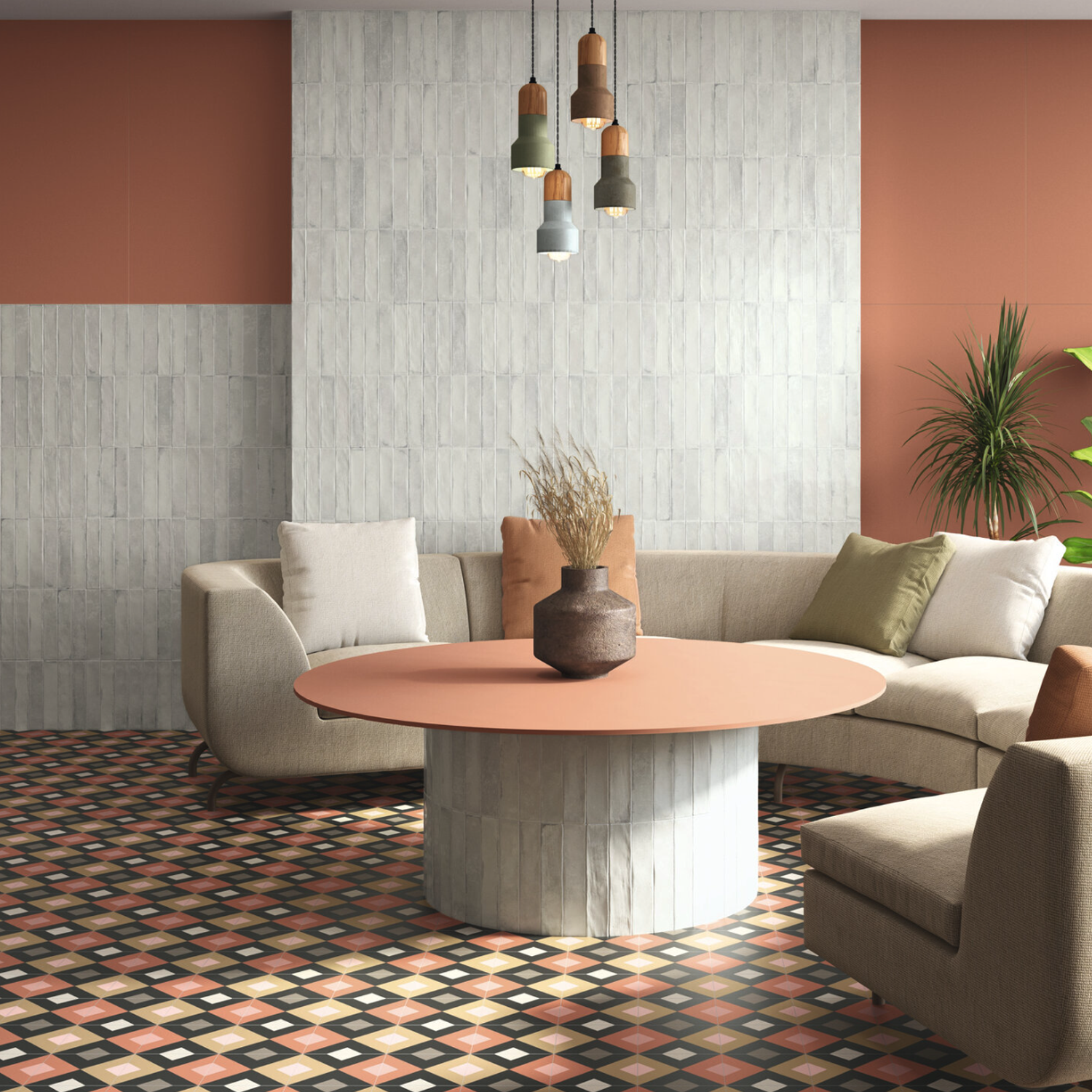 Modern living room with a round, coral table, beige curved sofas, patterned Savannah - White tile floor, pendant lights, and a vase with dried grass. Walls are half coral, half light gray tile.