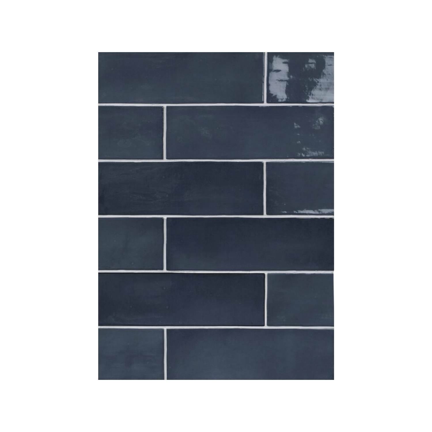 Seville - Indigo rectangular ceramic tiles in a deep indigo hue are arranged in a staggered brick pattern, featuring a mix of glossy and matte finishes. Each tile is separated by thin light gray grout lines.