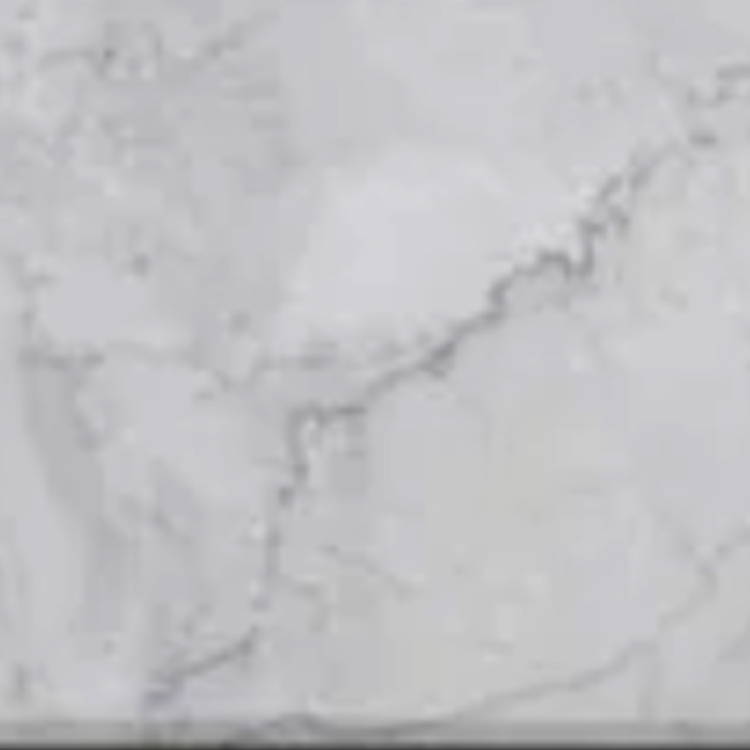 Venatino Carrara Thresholds feature a light gray marble surface accented with subtle white and dark gray veining, offering a natural, smooth, and elegant stone texture.