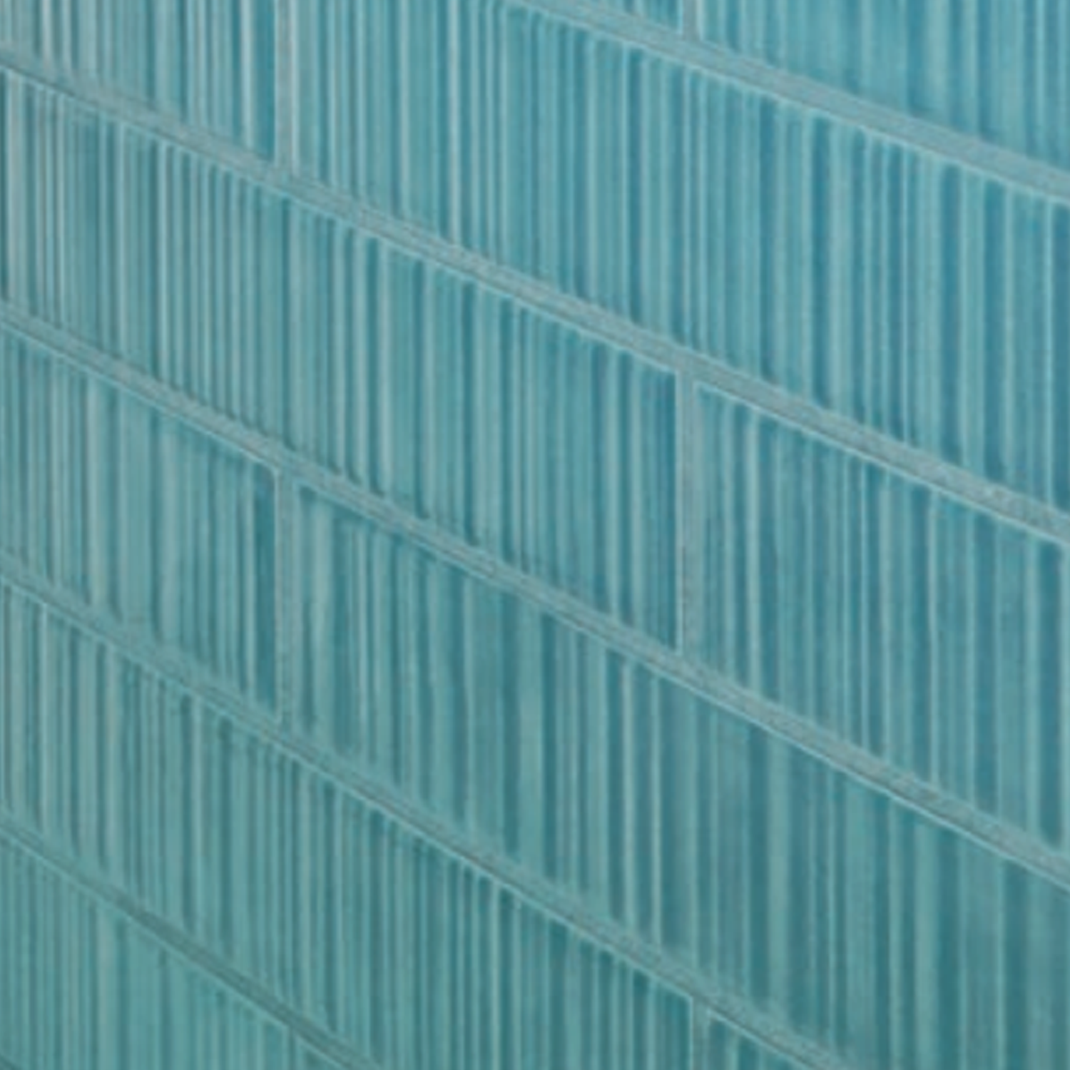Close-up of a wall featuring Vibrant - Aqua rectangular blue tiles, arranged in a staggered brick pattern, each tile enhanced with vertical grooves for added texture.