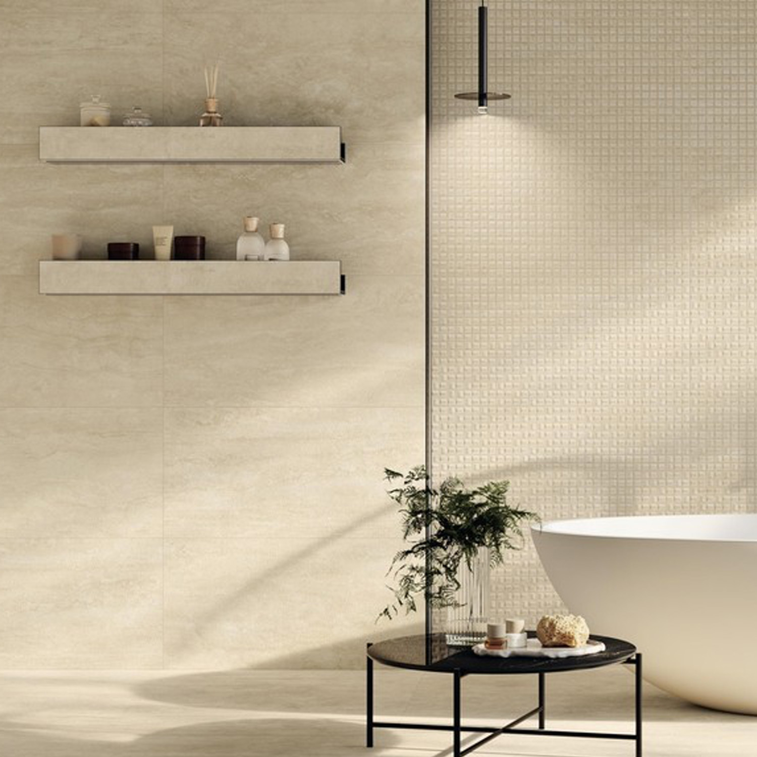 Modern bathroom featuring Marvel T - Navona White tiles on the walls, floating shelves displaying toiletries, a round black table with a plant, and a white freestanding bathtub beneath a ceiling light.