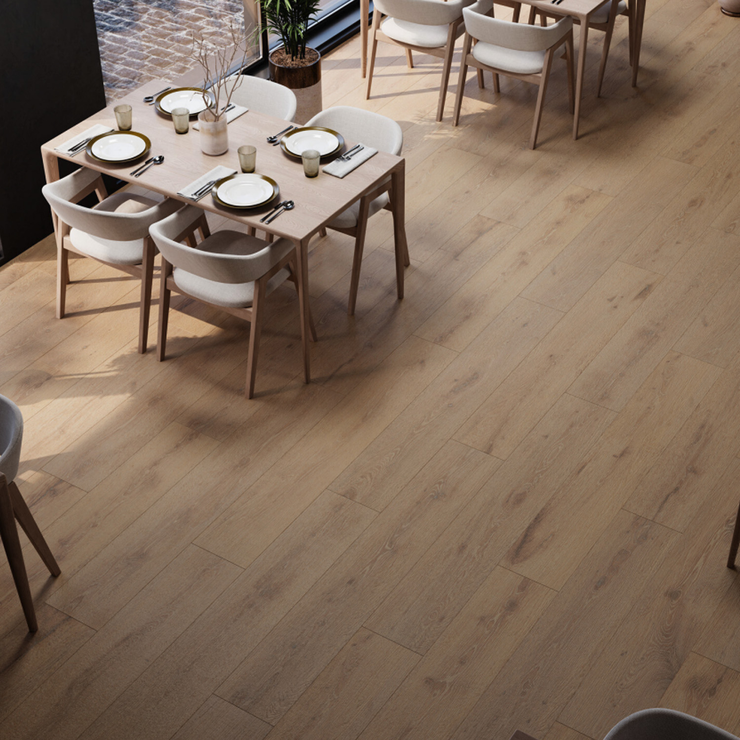 A modern restaurant featuring Oslo - Roble light wooden floors, neatly set tables for four, cream-colored chairs, and large windows that fill the space with natural light.
