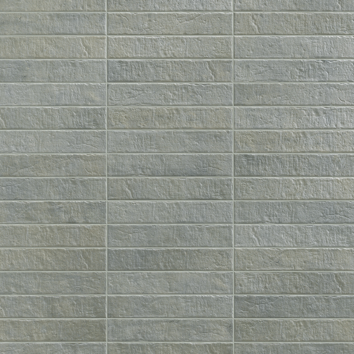 Tyrrhenia - Lagoon tiles are arranged in a grid pattern, with each rectangular tile showcasing a rough, textured gray surface and thin grout lines separating them both horizontally and vertically.