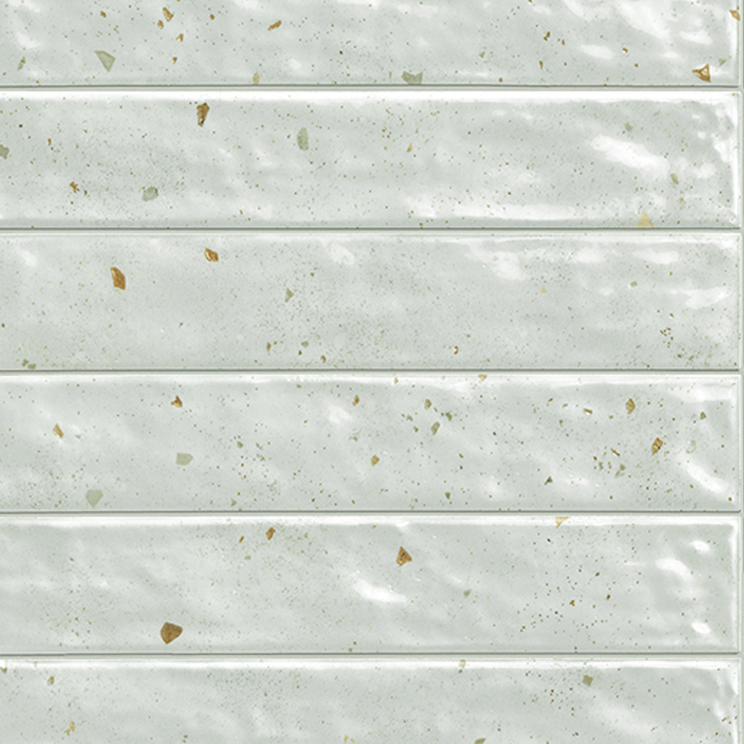 Via Del Sale - Sage features glossy, rectangular light green tiles with subtle speckles and delicate gold flecks, arranged horizontally. The surface showcases a slightly uneven, handcrafted texture.