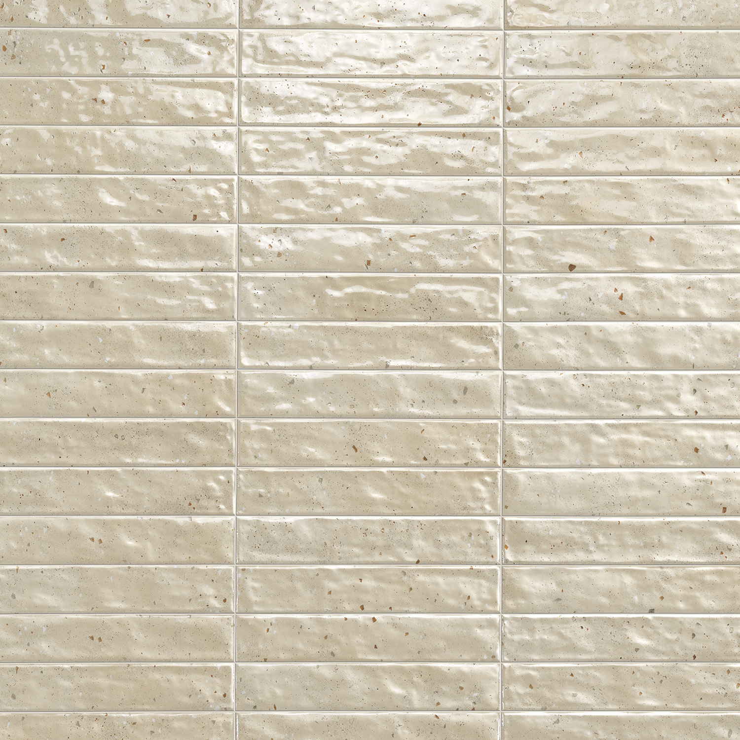 Via Del Sale - Sand tiles feature a glossy beige finish with subtle speckles, a slightly uneven surface texture, and are arranged in a rectangular horizontal grid pattern.