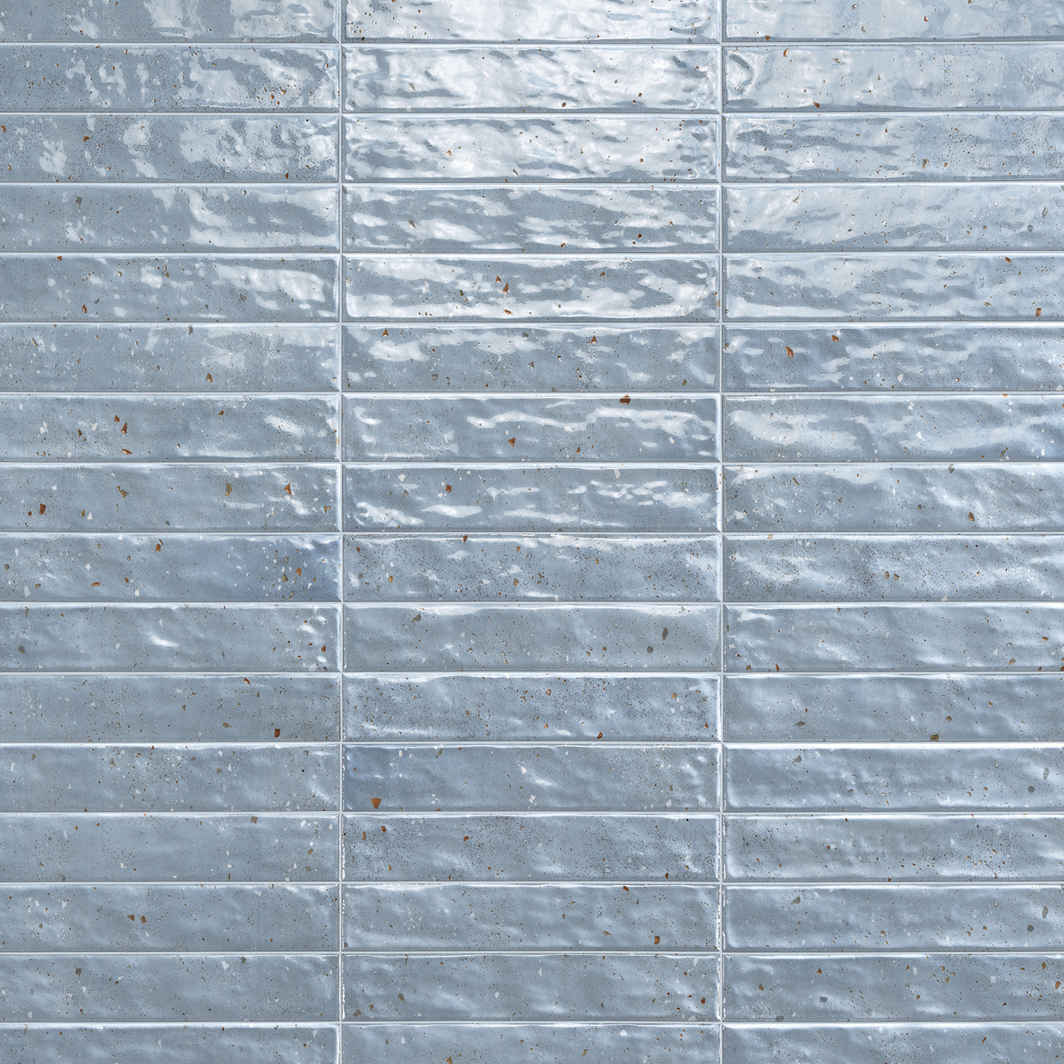 Via Del Sale - Sky tiles are light blue and rectangular, featuring a glossy, slightly uneven surface. Arranged in a horizontal grid pattern, they display subtle speckles and color variations that create a textured, reflective look.