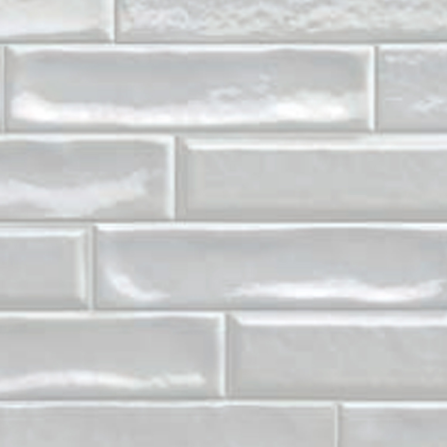 Vibe - Artic Snow tiles are glossy white rectangular subway tiles arranged in a horizontal brick pattern, featuring a slightly wavy texture and subtle surface reflections.