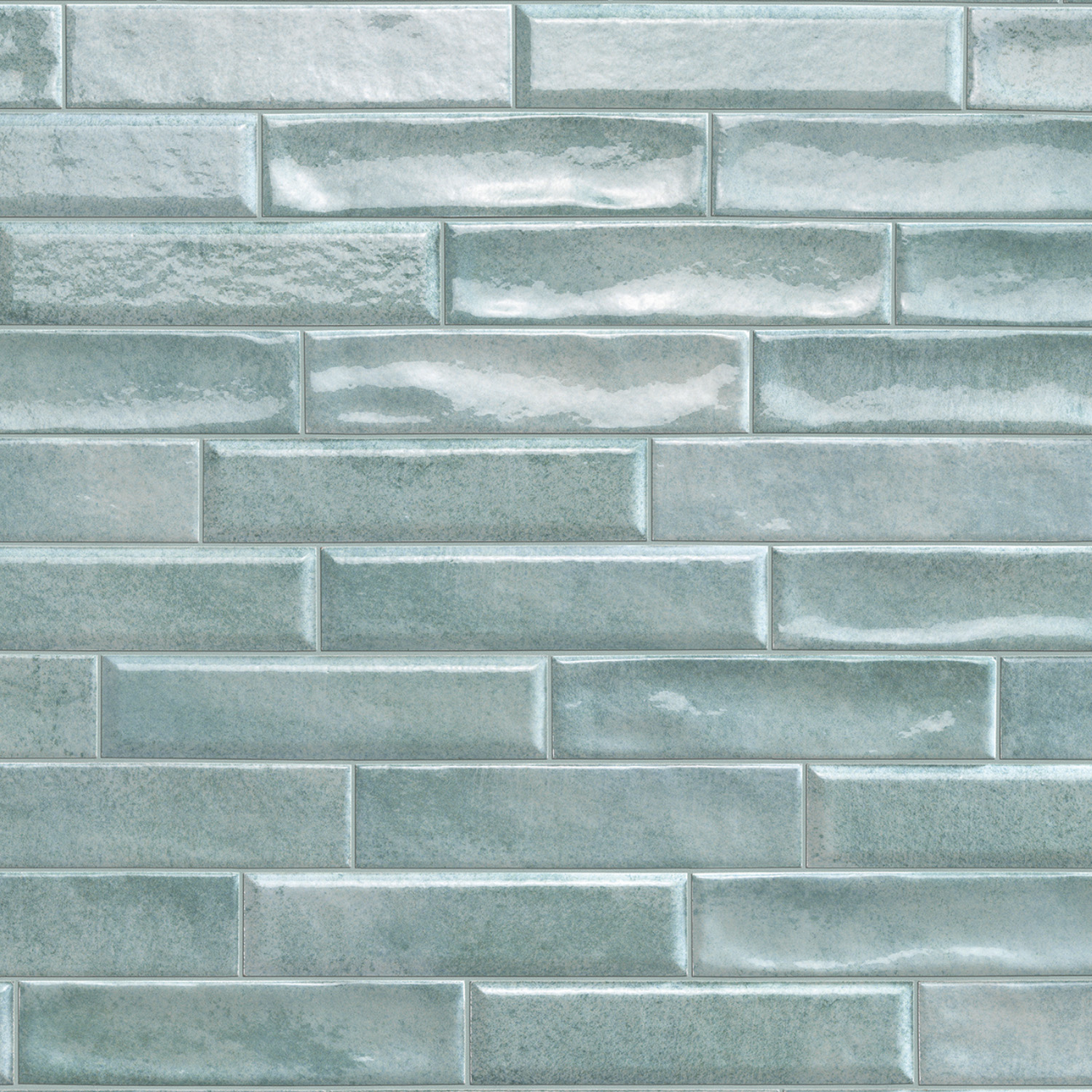 Vibe - Mint Leaf glossy light blue rectangular tiles are arranged in a brick pattern, creating a smooth, reflective, and modern wall surface with subtle texture and color variations on some tiles.