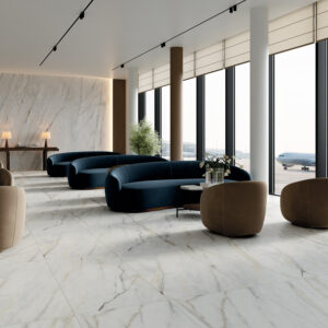 The modern airport lounge features striking Calacatta Bluette marble floors, large windows, blue and brown seating, small tables, potted plants, and offers views of two planes on the tarmac. Bright daylight fills the spacious, stylish room.